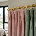 Stylish pink curtains framing a bright New York City apartment window.